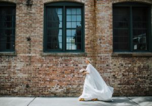 Bridal cape by Tatyana Merenyuk, Satin sheath gown by Theia Bridal