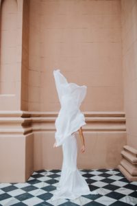 Bridal cape by Tatyana Merenyuk, Satin sheath gown by Theia Bridal