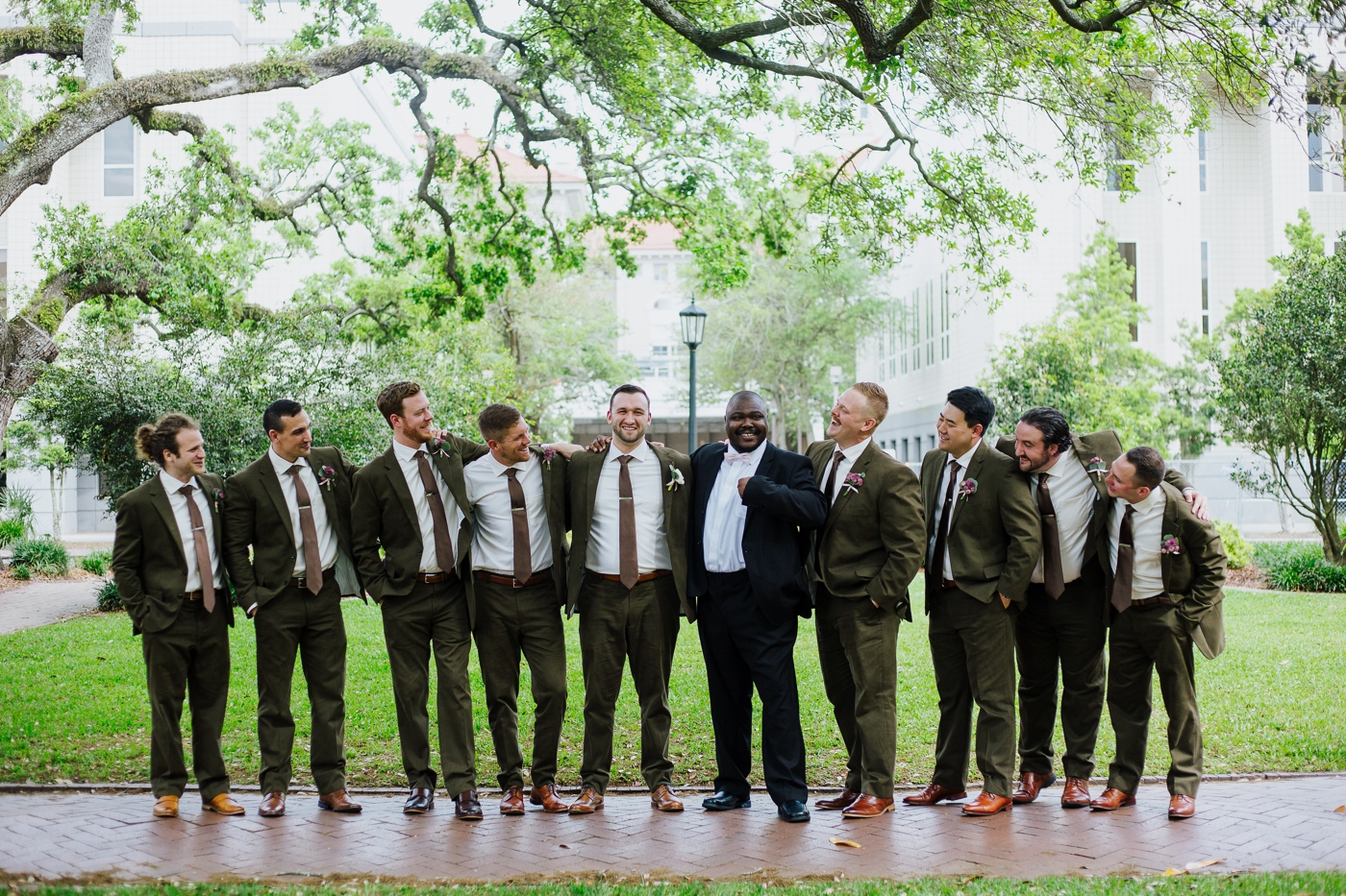 Groom and groomsmen in olive suits from Mens Warehouse