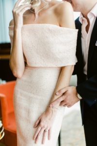 Bride in a classic fitted gown with a cuff neckline and embroidery by Lela Rose