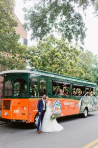 Bride and groom in front of Old Town Trolley in Savannah
