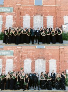 Groom and bridal party portraits in downtown Savannah in front of a red brick wall
