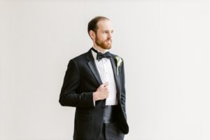 groom in black tux