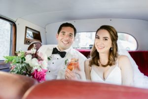 bride and groom with classic car