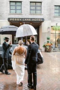 bride and groom in rain