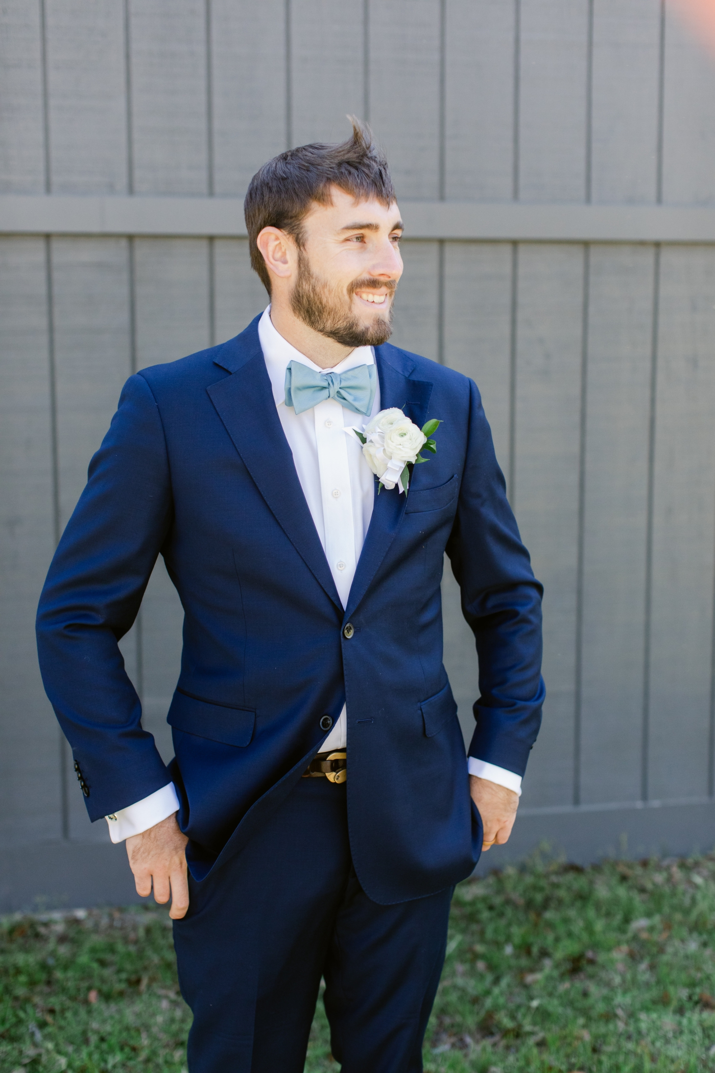 groom in navy blue suit with blue bowtie