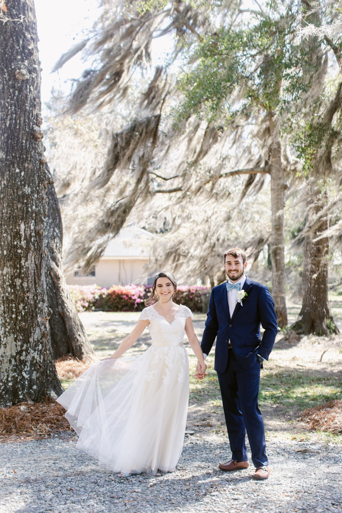 bride and groom under large oak tree