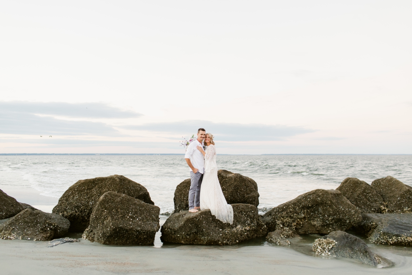 wedding portraits on beach rocks