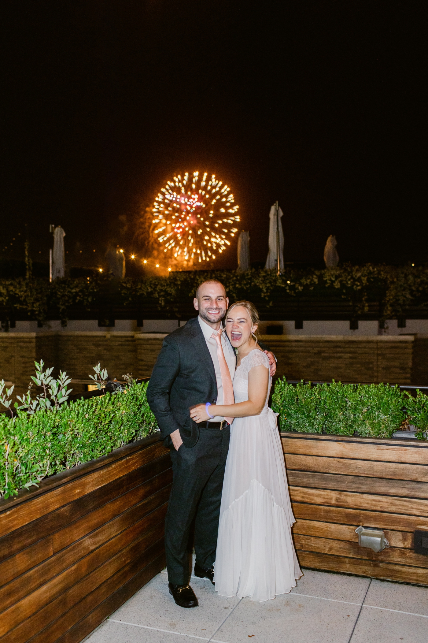 bride and groom under fireworks