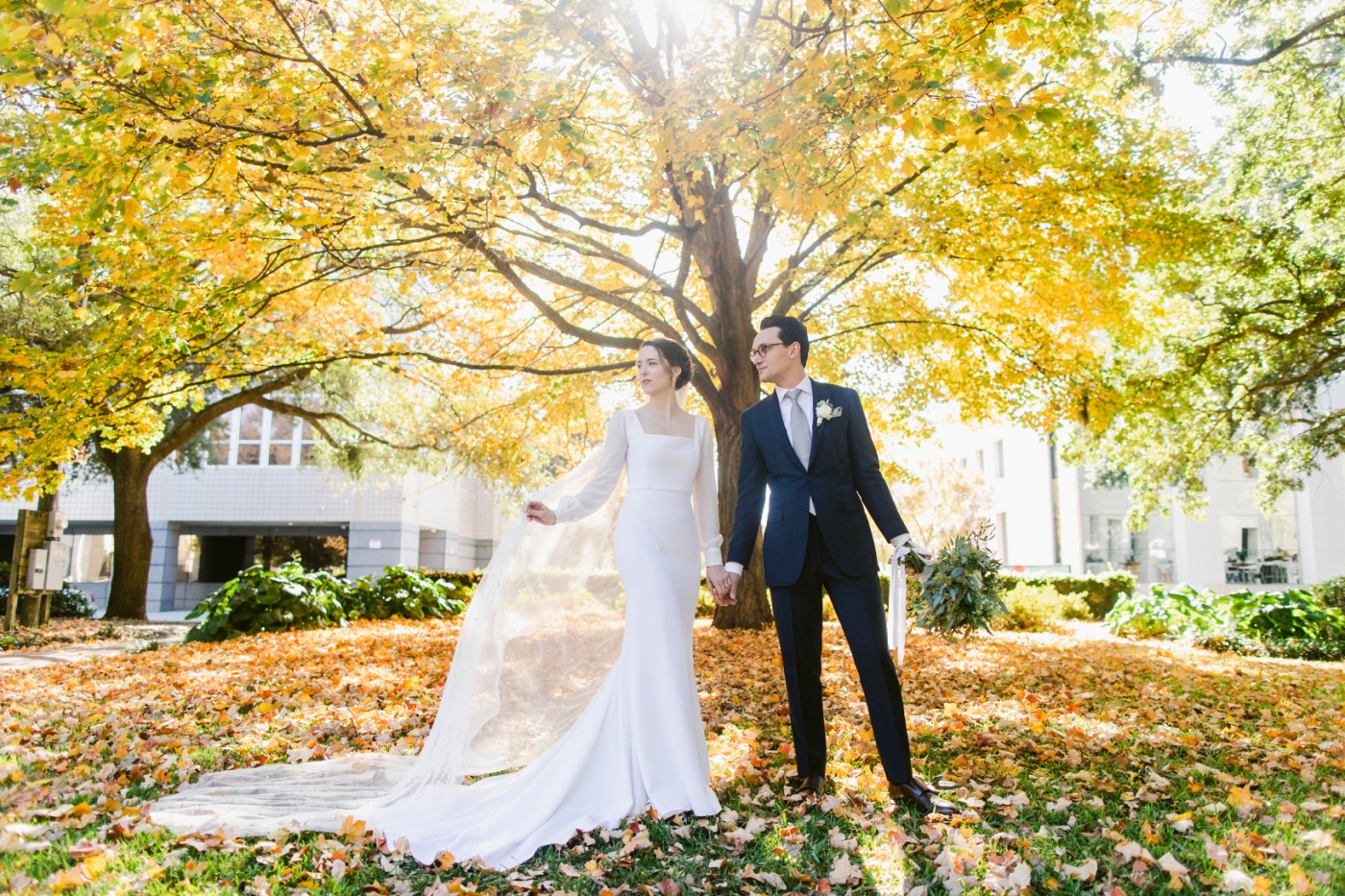 bride and groom portraits under fall leaves