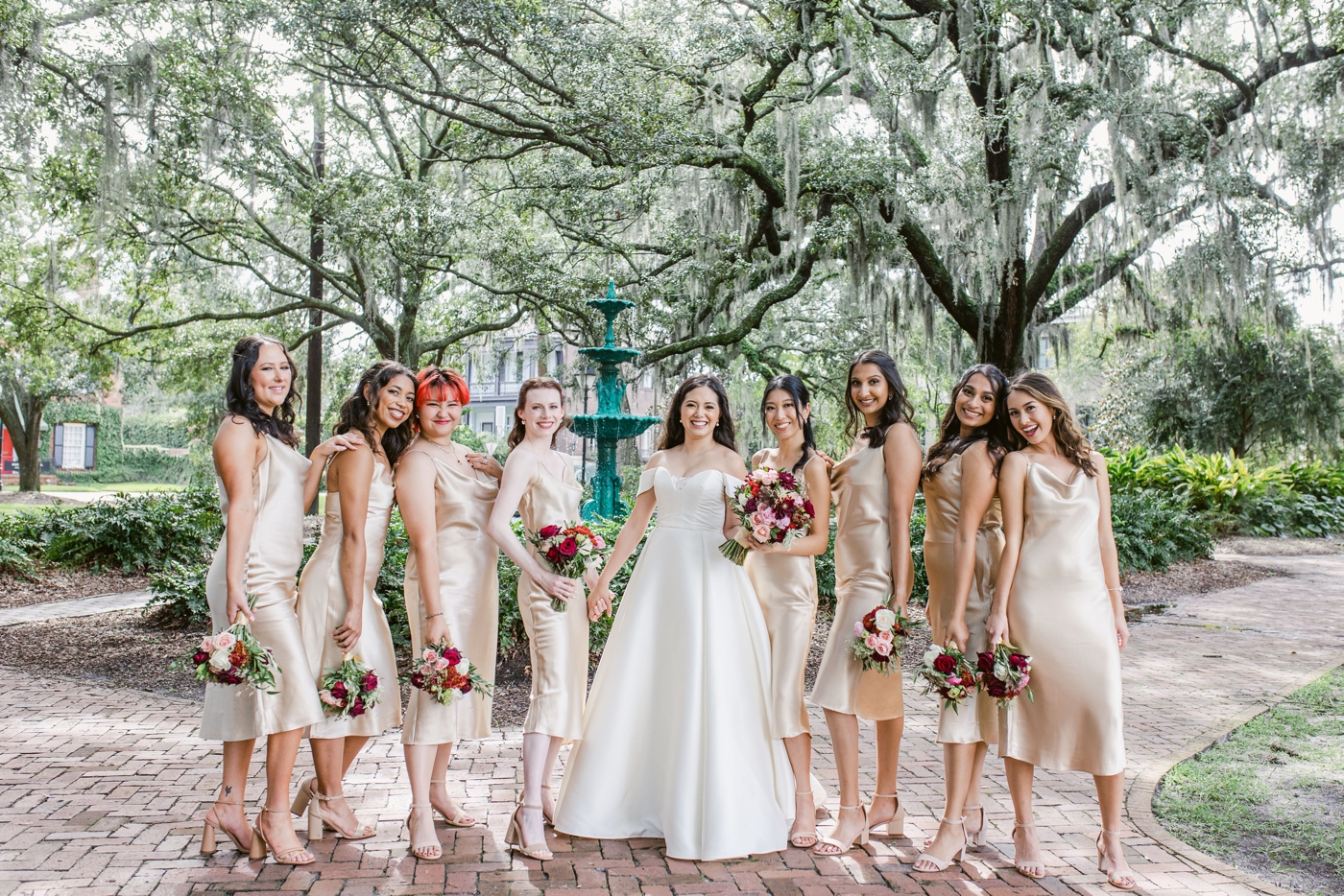 Bridesmaids in silk champagne dresses, with portraits in Historic Savannah