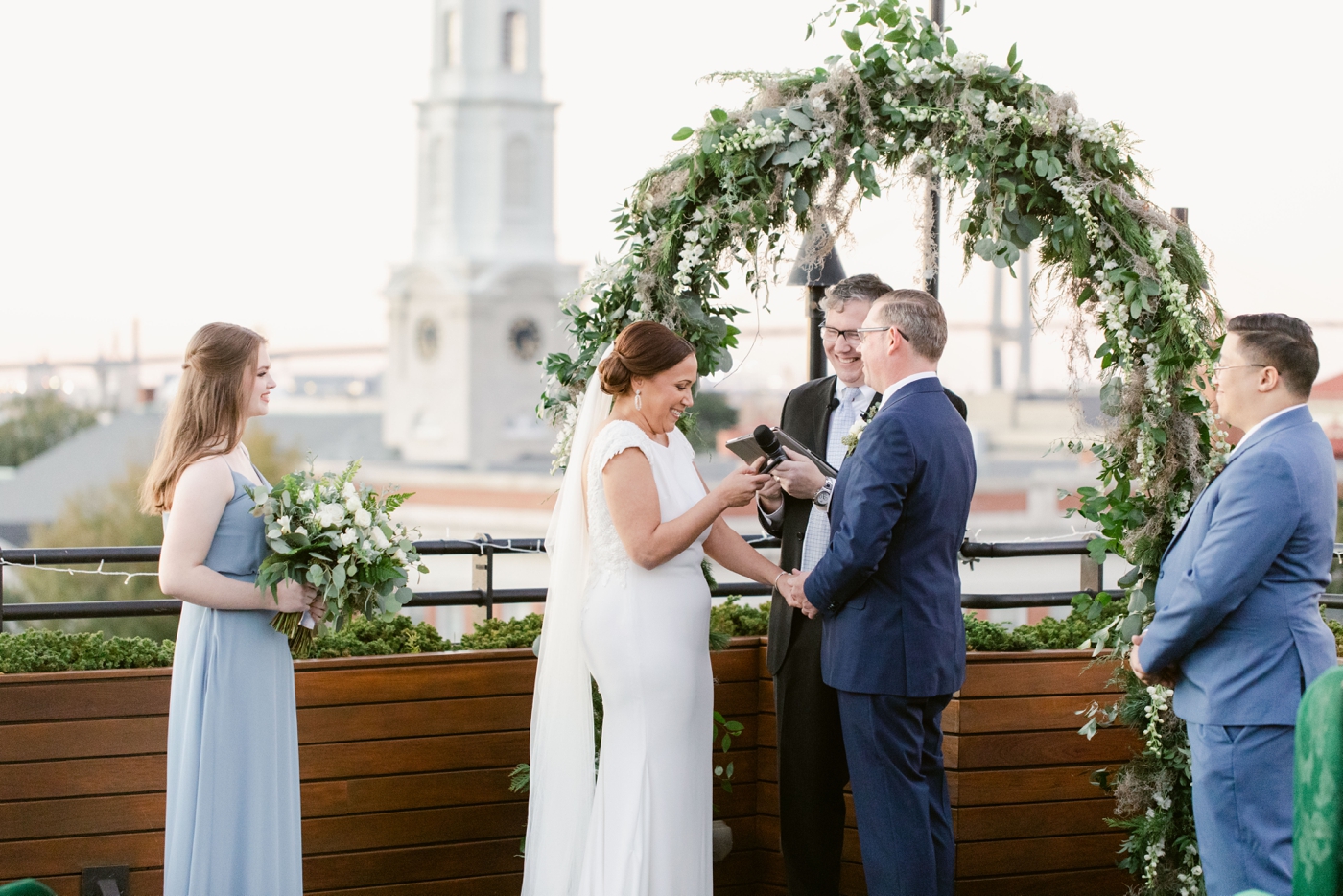 Couple reading their vows at their sunset rooftop ceremony in Savannah