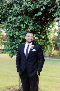 A groom smiling.