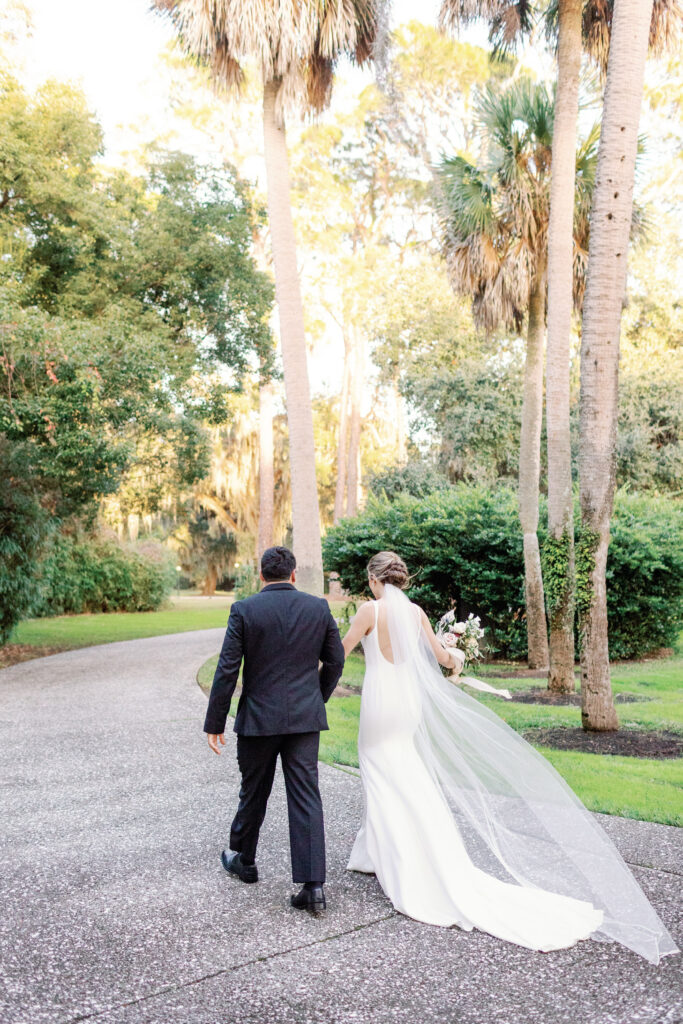 A bride and groom walking away.
