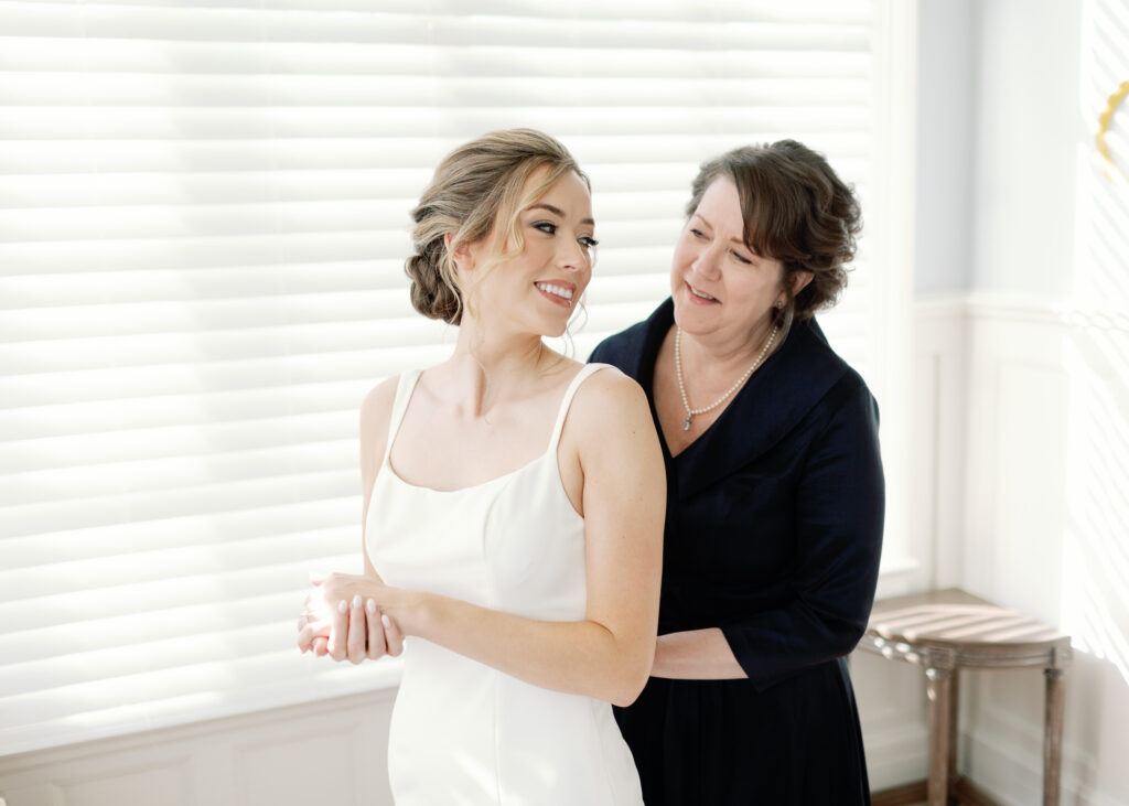a bride smiling at her mother.