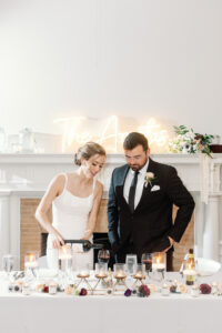 A bride pouring a glass of wine.