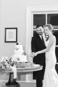 Bride and groom cutting a cake.