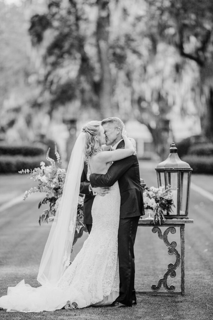A groom kisses his bride. 