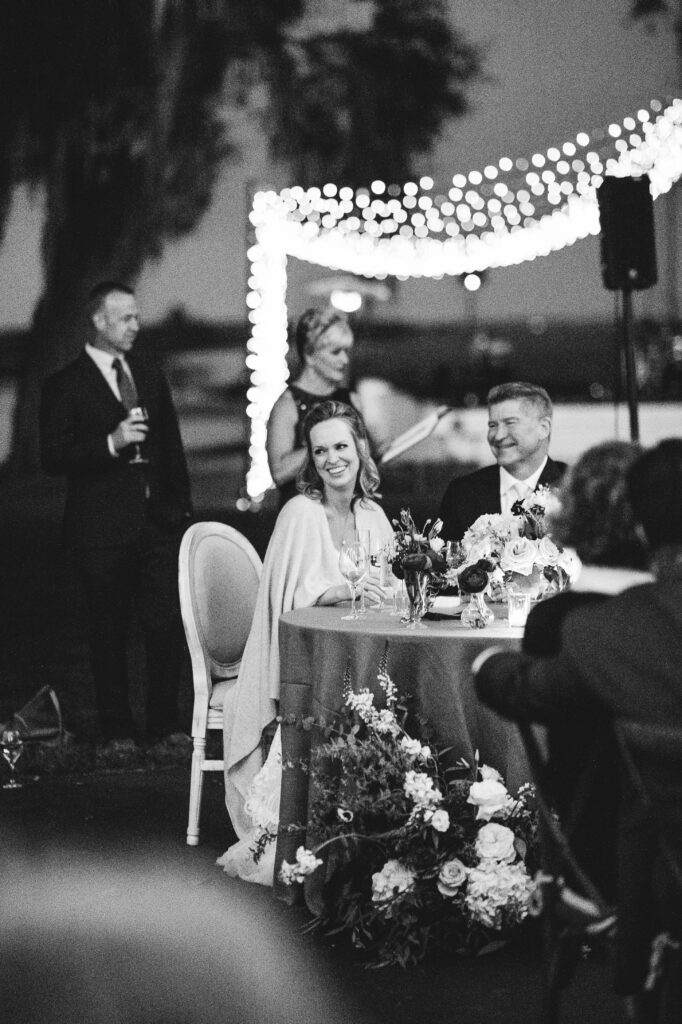 A bride sits at her wedding reception. 