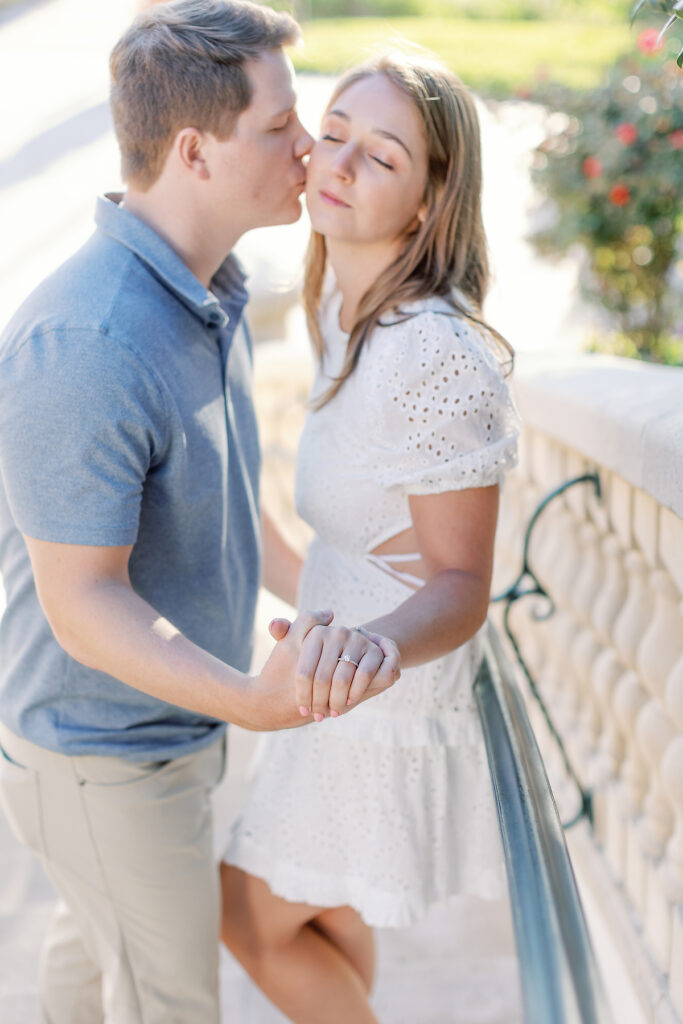 A couple kisses tenderly for their Sea Island Engagement. 