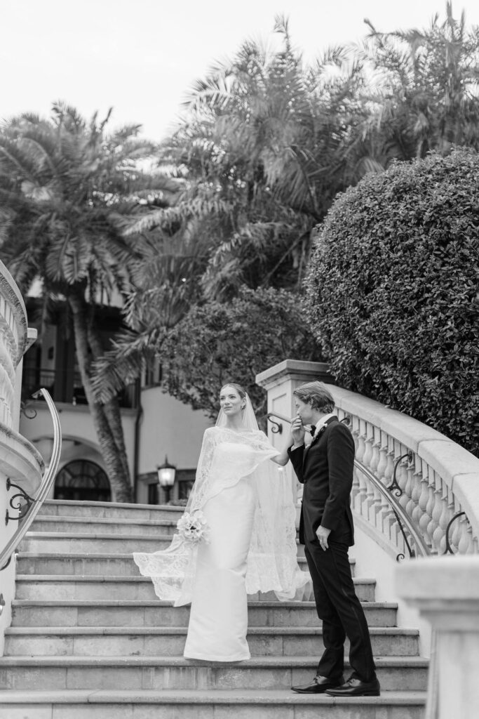 A bride and groom walking down stairs. 