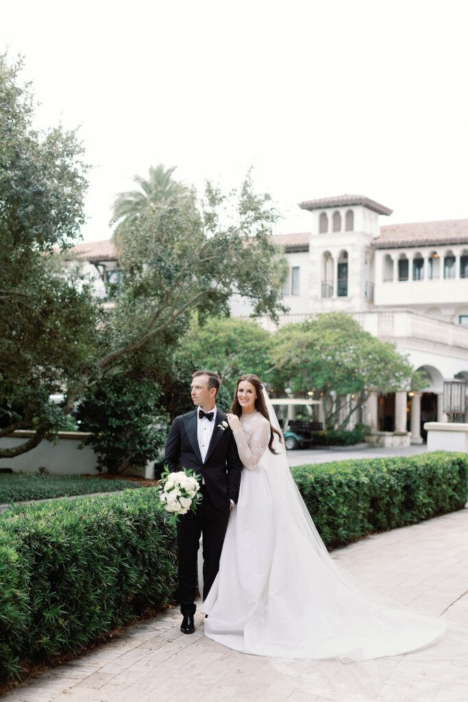 Bride and groom smiling outside of the Cloister