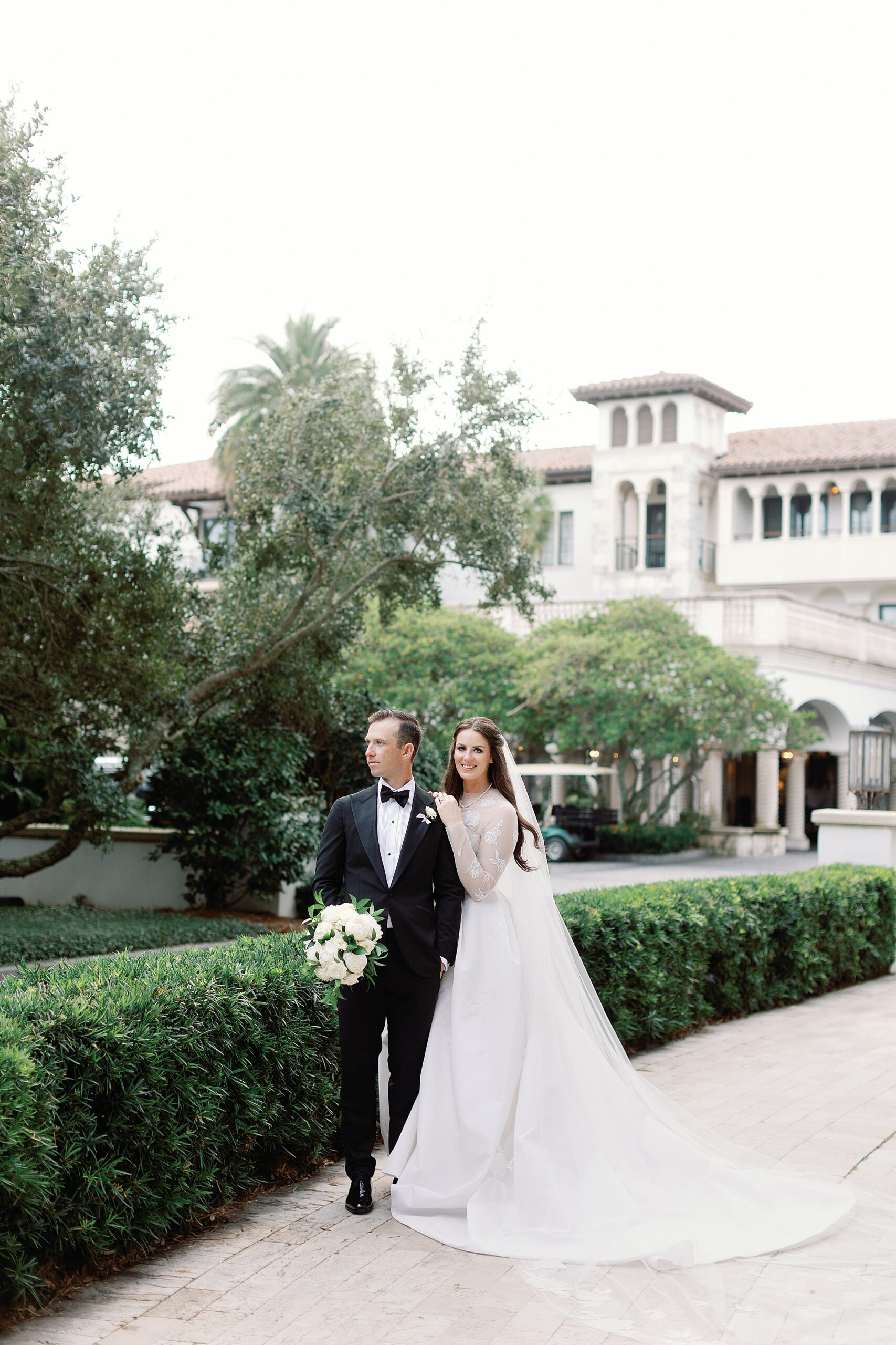 Bride and groom smiling outside of the Cloister